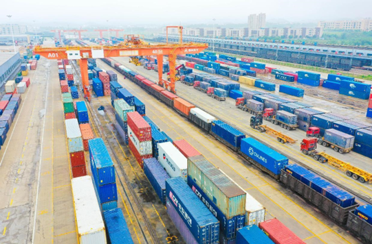 Containers are handled at an international land port in Ganzhou, east China's Jiangxi province, May 12, 2022. (Photo by Hu Jiangtao/People's Daily Online)