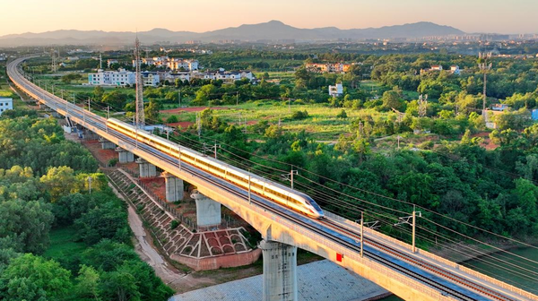 A Fuxing bullet train runs across Longling township, Nankang district, Ganzhou, east China's Jiangxi province on the Ganzhou-Shenzhen high-speed railway, July 10, 2022. (Photo by Zhu Haipeng/People's Daily Online)