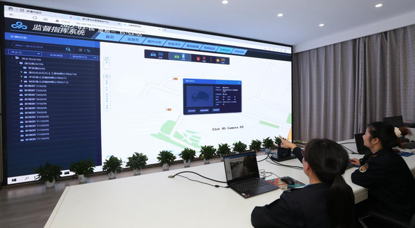 Urban management officers in Lianhua county, east China's Jiangxi province check and verify information on a smart urban management platform, March 16, 2022. (Photo by Li Xiaobin/People's Daily Online)