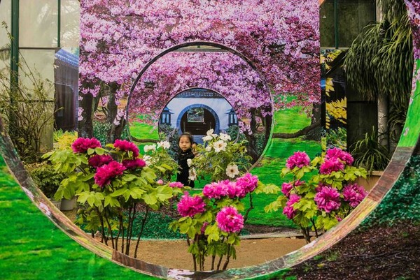 A girl poses at the South China National Botanical Garden, formerly known as the South China National Botanical Garden in Guangzhou, south China's Guangdong province, Feb. 9, 2021. (Photo by Liu Runchan/People's Daily Online)