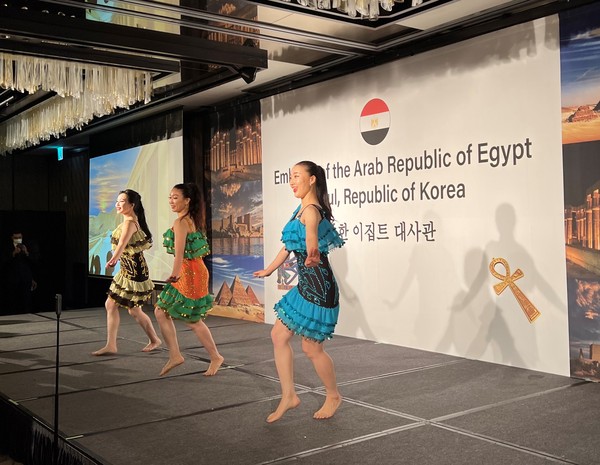 Three women dancers present a quick-step dance performance.