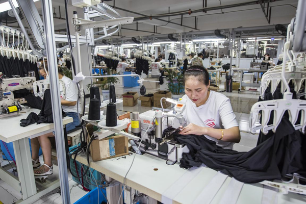 Clothes to be exported are produced in a workshop of a garment factory in Fanchang district, Wuhu, east China's Anhui province, July 20, 2022. (Photo by Xiao Benxiang/People's Daily Online)