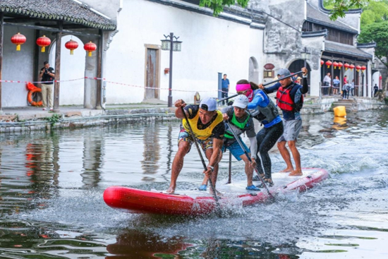 A stand-up paddling tournament is held in Huzhou, east China's Zhejiang province, May 30, 2021. (Photo by Tu Xudong/People's Daily Online)