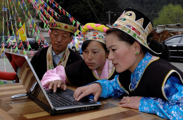 Residents from a village in Nyingchi, southwest China's Tibet autonomous region browse news on the internet during an activity aiming to introduce broadband services to Tibetan villages, April 10, 2012. (Photo by Li Weiming/People's Daily Online)