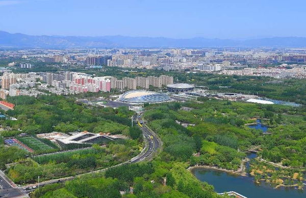 Photo taken on April 22, 2022 shows the National Speed Skating Oval surrounded by trees in Beijing. (Photo by Sun Lijun/People's Daily Online)