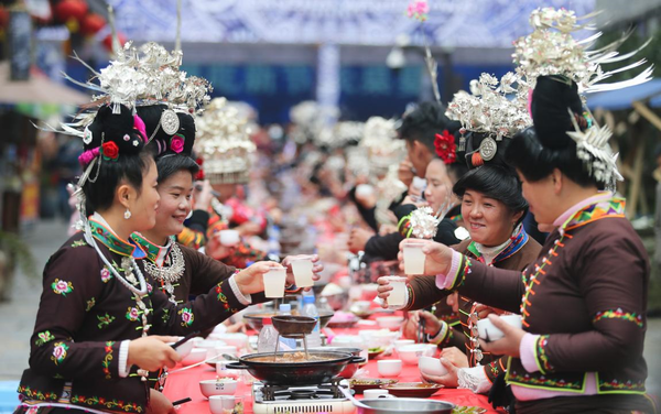 Villagers of Miao ethnic group make a toast during a traditional Miao ethnic harvest festival in a village in southwest China's Guizhou province, Oct. 18, 2020. (Photo by Zhang Hui/People's Daily Online)