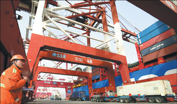 An employee oversees loading of cargo bound for the United States at Qingdao Port in Shandong Province.