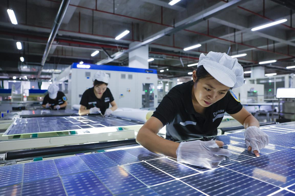 Technicians inspect the quality of photovoltaic parts in a workshop of an energy technology company in Hefei, east China's Anhui province, Sept. 13, 2022. (Photo by Zhao Ming/People's Daily Online)