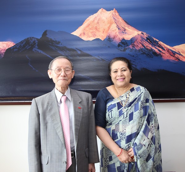 Ambassador Prof. Dr. Jyoti Pyakuryal (Bhandari), right, poses with Publisher-Chairman Lee Kyung-sik of The Korea Post media, publisher of 3 English and 2 Korean-language news publications since 1985.