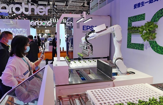 A 6-axis robot developed by Japanese electronics company Seiko Epson Corporation that can screen and grow seedlings attracts visitors at the fourth China International Import Expo in Shanghai, November 2021. (Photo by Xu Congjun/People’s Daily Online)