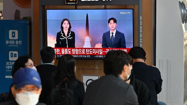 People watch a Yonhap News television screen showing a news broadcast with file footage of a North Korean missile test at the Seoul railway station on Nov. 2, 2022.