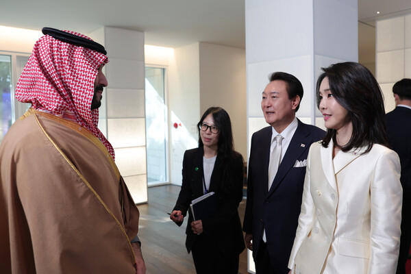 First Lady Madam Kim Keon-hee (right) speaks with with Crown Prince Muhammad bin Salman of the Kingdom of Saudi Arabia (left) together with President Yoon Suk-yoel (second from left). First Lady Kim is told apart from most of her predecessors for youth and outstanding beauty.
