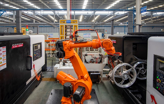 Motorcycle wheels are manufactured by a robotic arm in a digital workshop of a Zhejiang-based company, March 2022. (Photo by Hu Xiaofei/People's Daily Online)