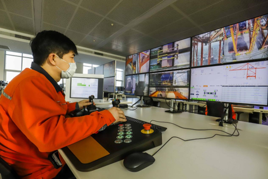 A worker controls terminal devices from an intelligent control center of the Tangshan Port, north China's Hebei province, Dec. 11, 2020. (Photo by Liu Mancang/People's Daily) 