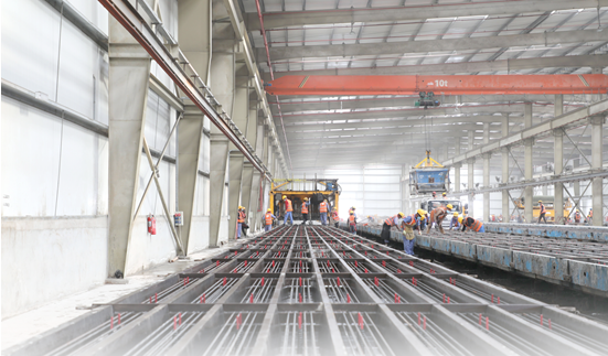 Chinese technicians work on a crosstie production line for the second stage of the Etihad Rail national rail network in the United Arab Emirates, September 2022. (Photo by Shen Xiaoxiao/People's Daily)