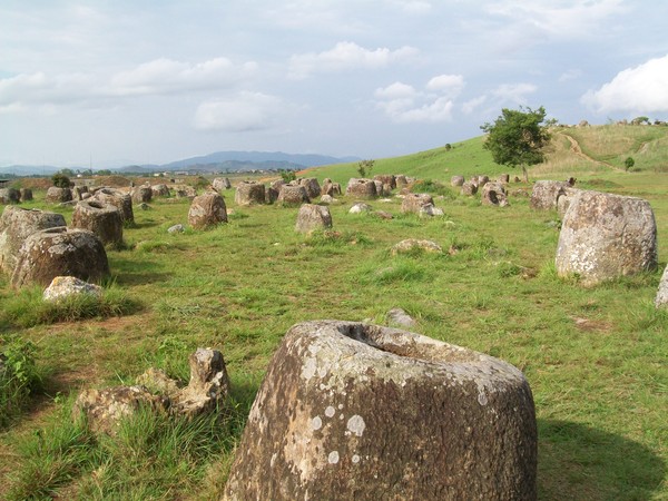 Plain of Jars  : The Plain of Jars is widely regarded as the most unique and intriguing of all Laotian attractions. A huge area surrounding Phonsavan, the capital city of Xieng Khouang Province, is littered with stone jars, yet no one knows why they are there. The mysterious jars are considered to be about 2,000 years old and were carved from sandstone and granite in a variety of sizes ranging from very small to roughly 3.5 metres high. According to legend, they were built to hold rice wine, although some say they were built to store the dead. The role of the jars is still debated today.Sites 1, 2, and 3 are the three most popular jar sites to visit among the many. The main reason is that they are resistant to UXO (unexploded ordinance). Nonetheless, travelers are encouraged to stick to well-traveled paths because Laos is the world's most frequently bombed/mined country. During the Vietnam War, this area was heavily bombed, and some of the bombs did not detonate. The largest jar is located at Site 1. Sites 2 and 3 provide lovely views of farmlands and villages from the tops of tiny hills. Location: In and around Phonsavan, the provincial capital of Xieng Khouang Province in northeast Laos.
