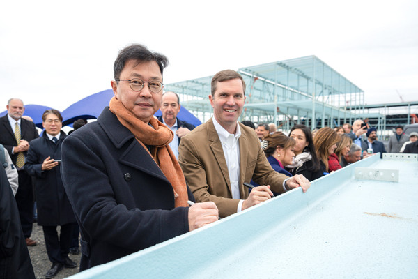 SK Group Executive Vice Chairman Chey Jae-won (left) and Kentucky Gov. Andy Beshear pose for a photo during a beam signing event at the groundbreaking ceremony of BlueOval SK Battery Park in Glendale, Kentucky, on Dec 5, 2022.