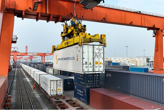 Containers are unloaded from a train carrying fresh fruits that arrived in Chengdu, capital of Sichuan province, via the China-Laos Railway, December 2022. It is the first delivery of imported fruits via the railway to the city. (Photo by Bai Guibin/People's Daily Online)
