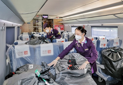 Attendants inspect and check express delivery parcels on a high-speed train from Quzhou, east China's Zhejiang province to Shanghai, November 2022. (Photo by Zhou Wei/People's Daily Online)