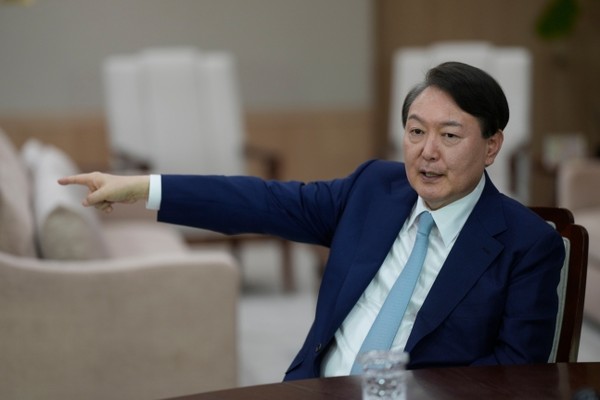 In an interview with the Associated Press at the Presidential office on Jan. 10, President Yoon Suk-yeol points to a phone, a hotline (direct phone) with North Korean leader Kim Jong-un.
