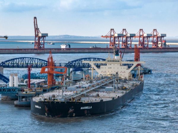 Cargos are unloaded from an oil tanker at a crude oil terminal of the Yantai Port in east China's Shandong province, Dec. 18, 2022. The cargo handling capacity of the Yantai Port for the first time exceeded 400 million tons in 2022, up 13.7 percent year on year. Its container throughput hit over four million twenty-foot equivalent units in 2022, up 13.9 percent from a year ago. (Photo by Zhang Chao/People's Daily Online)
