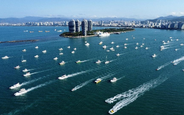 Yachts are seen sailing on the water in Sanya, south China's Hainan province, Feb. 7, 2023. (Photo by Ye Longbin/People's Daily Online)