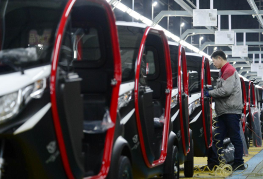 Electric vehicles are assembled in an manufacturing base in Runan county, Zhumadian, central China's Henan province, Feb. 8, 2023. (Photo by Sun Kai/People's Daily Online)