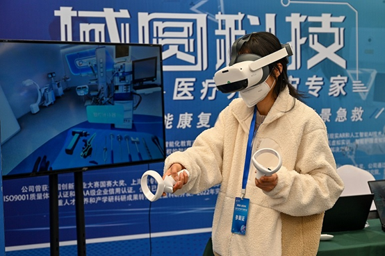 An employee of an exhibitor shows a virtual reality product at a metaverse conference and exhibition held in Kunshan, south China's Jiangsu province, Feb. 15, 2023. (Photo by Zhang Congyu/People's Daily Online)
