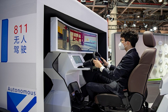 A man drives on a virtual driving simulator at the Global Digital Trade Expo held in Hangzhou, east China's Zhejiang province between Dec. 11 and 14, 2022. (Photo by Hu Xiaofei/People's Daily Online)