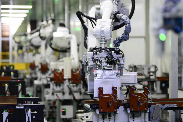 Robotic arms are manufacturing power batteries for new energy vehicles in a workshop of a company in Ganzhou, east China's Jiangxi province, Feb. 8, 2023. (Photo by Hu Jiangtao/People's Daily Online)
