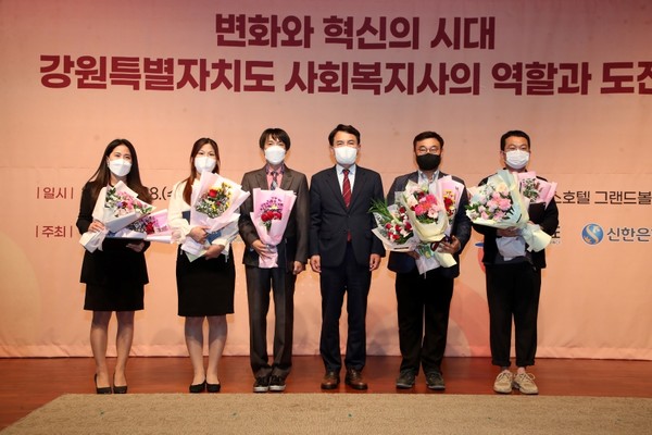 Governor Kim Jin-tae of Ganwon-do Province (fourth from left) and other officials take a commemorative photo at the opening ceremony of the 21st Gangwon-do Social Welfare Society Conference.