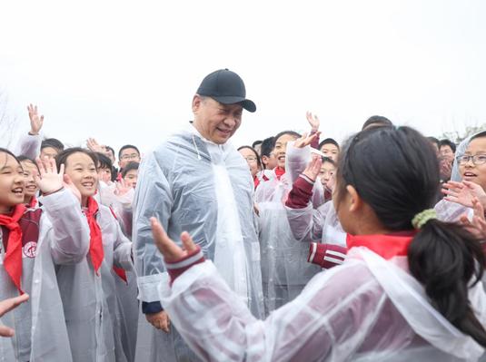 Chinese President Xi Jinping, also general secretary of the Communist Party of China Central Committee and chairman of the Central Military Commission, talks with young students during a voluntary tree planting activity in Beijing, capital of China, April 4, 2023. Xi and other leaders, including Li Qiang, Zhao Leji, Wang Huning, Cai Qi, Ding Xuexiang, Li Xi, and Han Zheng, planted trees with local people at a city park in the eastern district of Chaoyang in the spring shower. (Xinhua/Ju Peng)