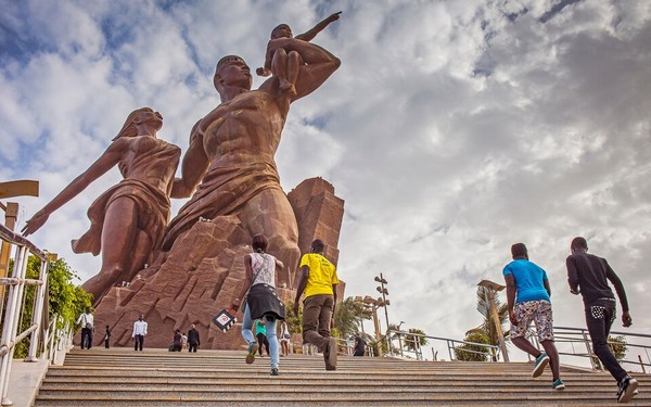 방문객들이 세네갈에 있는 아프리카 르네상스 기념탑으로 가는 계단을 걸어 올라가는 모습.