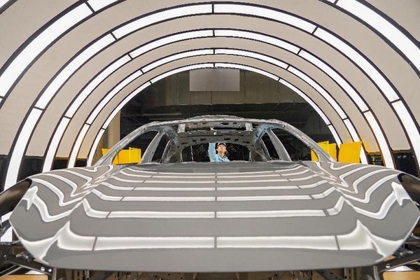 New energy vehicles are manufactured in an intelligent factory of Zeekr, a premium electric automobile brand owned by Chinese automaker Geely, in Ningbo, east China's Zhejiang province, March 28, 2023. (Photo by Zhang Yongtao/People's Daily Online)