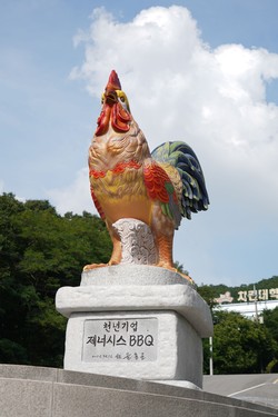 A chicken stone statue at the entrance to the Chicken University