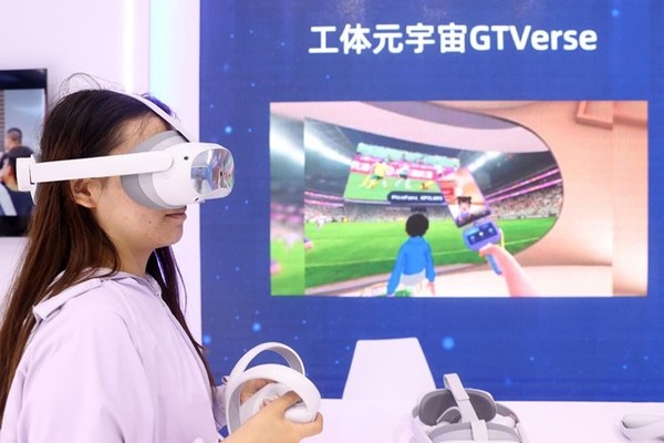 A woman experiences the metaverse wearing a virtual reality headset at the Global Digital Economy Conference 2023 in Beijing, July 4, 2023. (Photo by Chen Xiaogen/People's Daily Online)