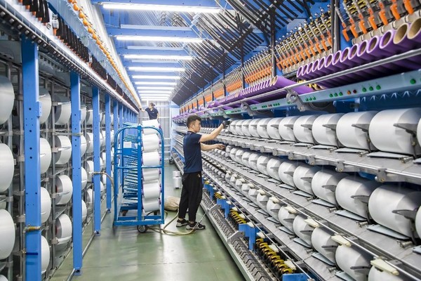 Products to be exported are manufactured in a smart workshop of a private textile enterprise in Suqian, east China's Jiangsu province, June 9, 2023. (Photo by Xu Rui/People's Daily Online)