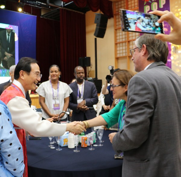 Mayor Park (left) shakes hands with each of the visiting members of the Diplomatic Corps.