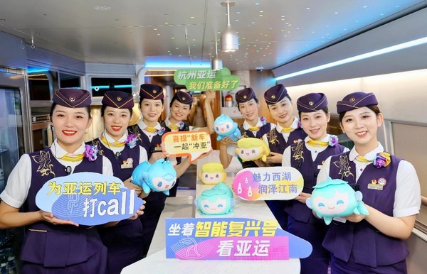 Crew members of a Fuxing bullet train specially designed for the Hangzhou Asian Games pose for a picture on the train in Hangzhou, east China's Zhejiang province, Aug. 4, 2023. (Photo by Zhou Wei/People's Daily Online)