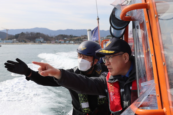 Kim Jong-Uk, head of the Korea Coast Guard, examines the lay of land in the preliminary inspection of the safety of fishing grounds on a high speed boat.