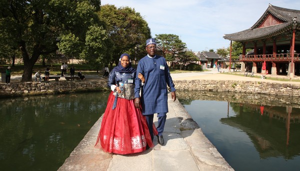 Ambassador and Mrs. Ali M Magashi of Nigeria (dean of the visiting members of the Seoul Diplomatic Corps that day) pose on the Ojak-kyo Bridge in front of the Gwanghallu Pavilion in the Namwon City.