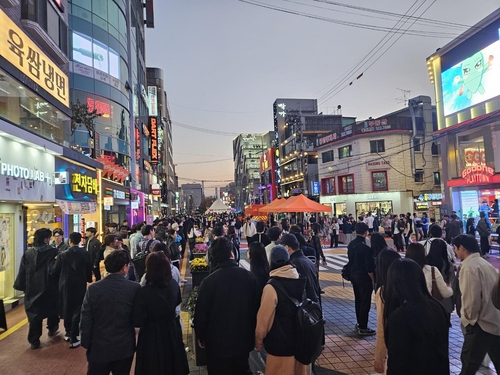 This photo, taken Oct. 28, 2023, shows people in Hongdae, one of Seoul's crowded entertainment areas, on the eve of South Korea marking one year after the deadly crowd crush in Seoul's Itaewon district that claimed 159 lives. 