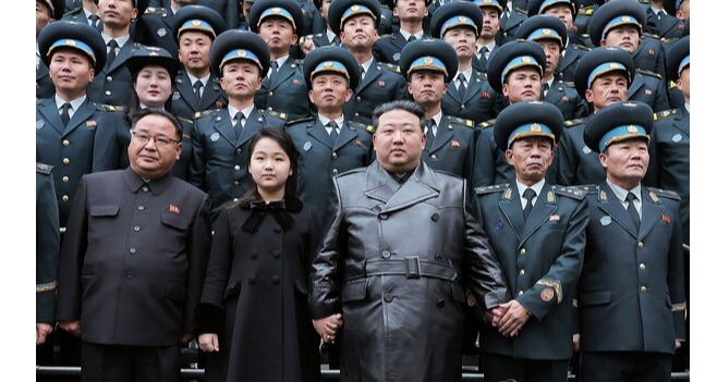 This photo, carried by North Korea's official Korean Central News Agency on Nov. 24, 2023, shows the North's leader Kim Jong-un (C) and his daughter (2nd from L, front row), believed to be named Ju-ae, posing for a photo with scientists and engineers who contributed to the country's latest launch of a military spy satellite, as he visited the National Aerospace Technology Administration the previous day. (For Use Only in the Republic of Korea. No Redistribution)