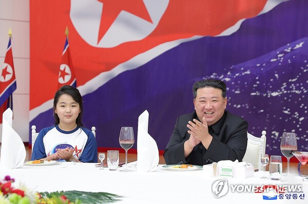 This photo, carried by North Korea's official Korean Central News Agency on Nov. 24, 2023, shows the North's leader Kim Jong-un (R) and his daughter, believed to be named Ju-ae, attending a banquet the previous day to celebrate the country's successful launch of a military spy satellite. (For Use Only in the Republic of Korea. No Redistribution) 