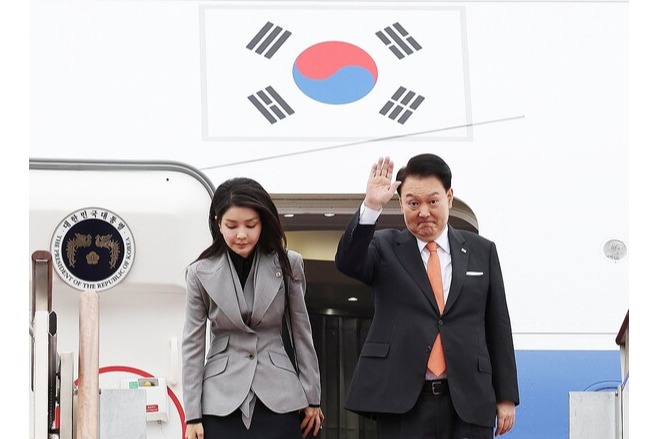 President Yoon Suk Yeol (R) and first lady Kim Keon Hee bid farewell at Seoul Air Base, just south of the capital, before departing for the Netherlands on Dec. 11, 2023.