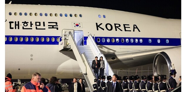South Korean President Yoon Suk Yeol and his wife, Kim Keon Hee, (on stairs) arrive at Amsterdam Airport Schiphol for a four-day state visit on Dec. 11, 2023.