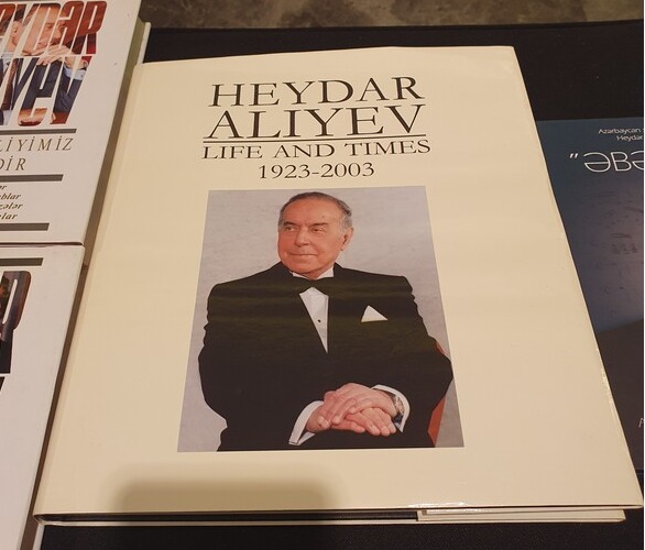 The portrait picture of the National Hero Heydar Aliyev of the Republic of Azerbaijan is show on the front cover of a book entitled, “Heydar Aliev, Life and Times 1923-2003” was also on display at the entrance of the reception venue.