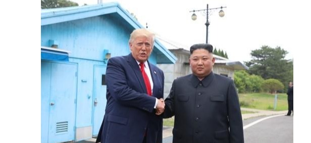 U.S. President Donald Trump (L) and North Korean leader Kim Jong-un shake hands at the inter-Korean border truce village of Panmunjom on June 30, 2019.