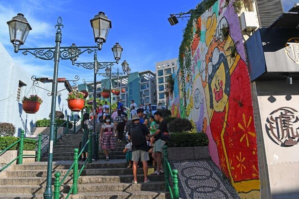 Tourists visit the Rua do Cunha, a souvenir street in Macao, Aug. 3, 2023. (Photo by Sun Lijun/People's Daily Online)