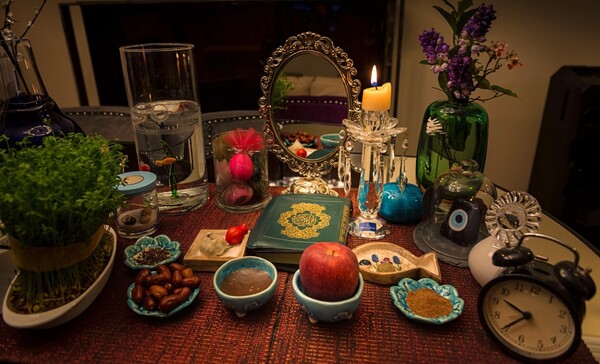 Haft Sin table as ornaments or for the sake of completeness. Holly Quran, Divan-e Hafez(poetry book), a mirror, coins(as a symbol of wealth), painted eggs, candle sticks, a bowl of water and a live goldfish, hyacinth, flowers, special sweets, nuts and so on…